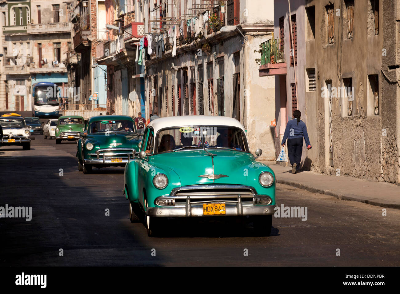 vintage US cars from the 50`s and coulourful buildings in Centro Habana, Havana, Cuba, Caribbean Stock Photo